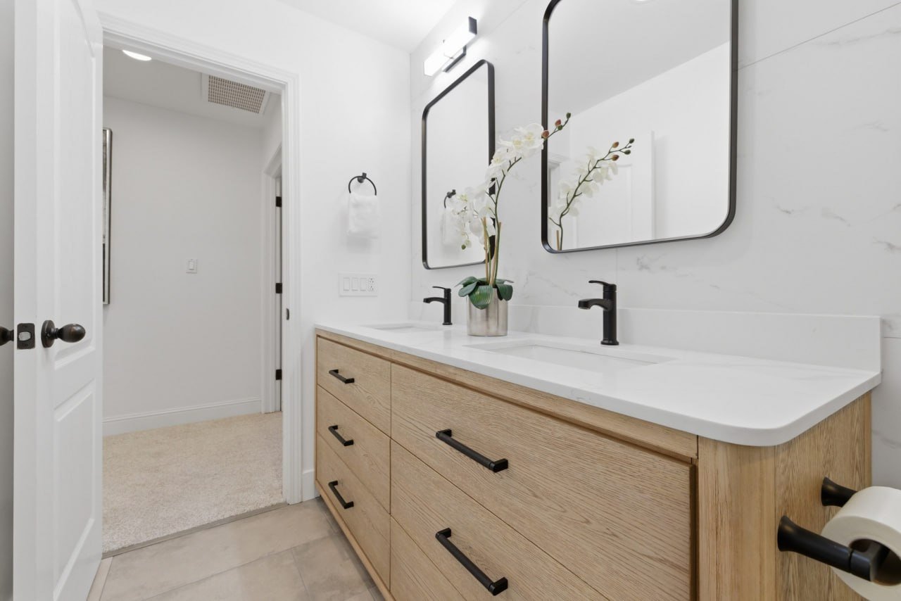 Primary bath remodel with white oak double vanity and black fixtures