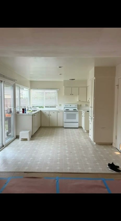 Original San Ramon kitchen before remodeling, with white cabinetry and a white range