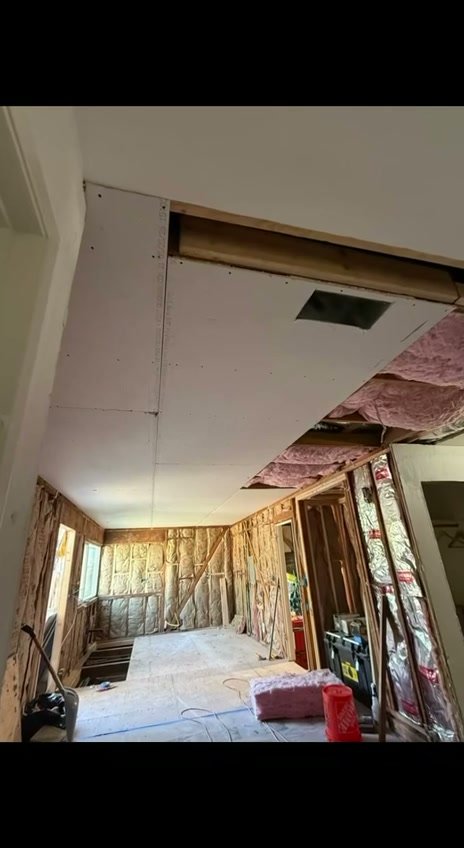 San Ramon kitchen during construction, with open wall framing and ceiling work
